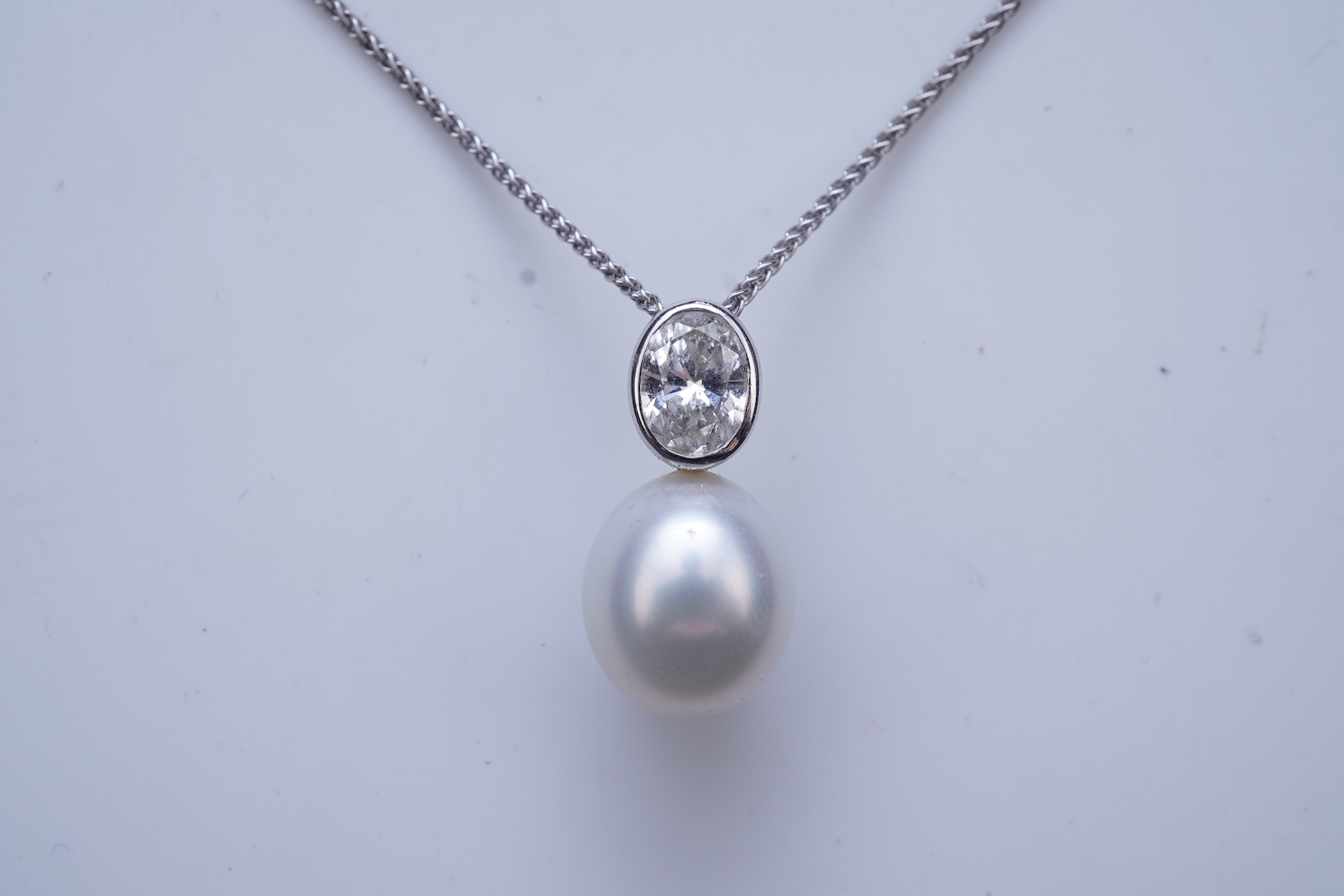 A cultured pearl and diamond pendant